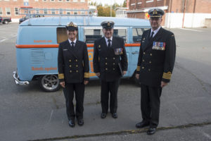 Honorary Captain (N) (HCapt (N)) Mandy Farmer pose in front of her Hotel Zed company van with Base Commander Captain (N) Steve Waddell, and Chief Petty Officer 1st Class (CPO1) Gino Spinelli, Base CPO, at the commencement of Canadian Forces Base (CFB) Esquimalt’s Base Divisions held at the Naden Drill Shed on 27 September 2016. Image by LS Ogle Henry, MARPAC Imaging Services ET2016-0362-02 © 2016 DND-MDN Canada